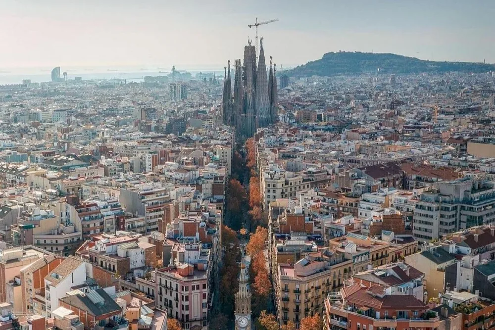 Aerial view of the Eixample with the Sagrada Família rising above the grid