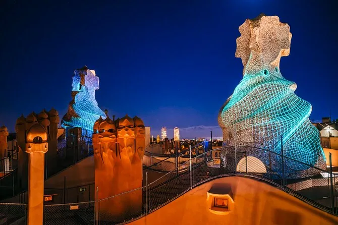 La Pedrera's rooftop chimneys lit in blue at night